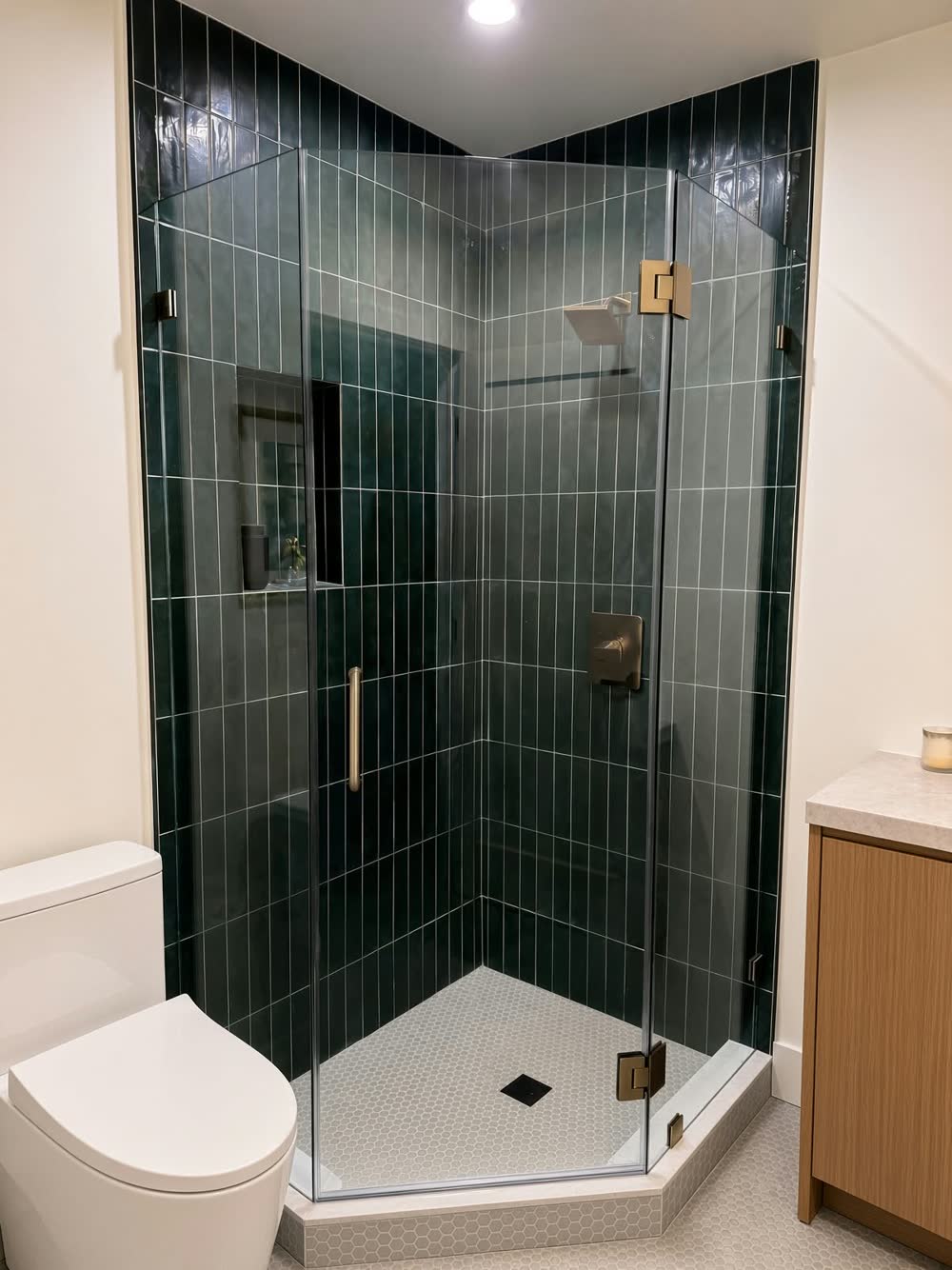 Neo-angle glass shower with deep green vertical tile and brushed-gold fixtures — ProRock Remodeling, Bay Area