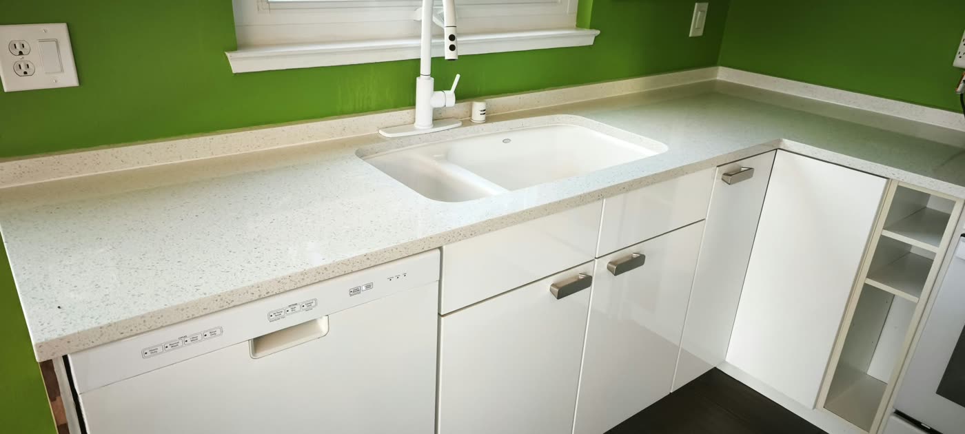 White kitchen with quartz countertops, a white undermount sink and green accent walls — ProRock Remodeling, Bay Area